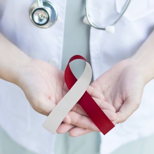 Dentist holding an oral cancer awareness ribbon