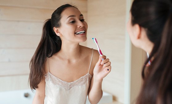 Woman smiling with a toothbrush
