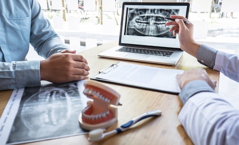 Dentist explaining the dental implant denture process