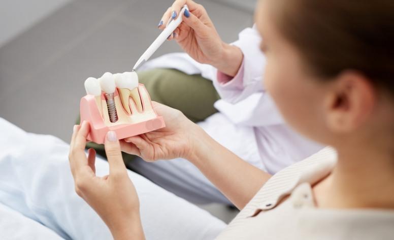 Dentist and patient discussing dental implant post operative instructions