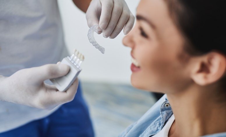 Dentist holding an Invisalign tray