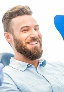 man smiling in dental mirror 