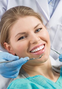 patient smiling while visiting dentist 