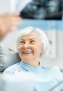 older patient looking at dentist 