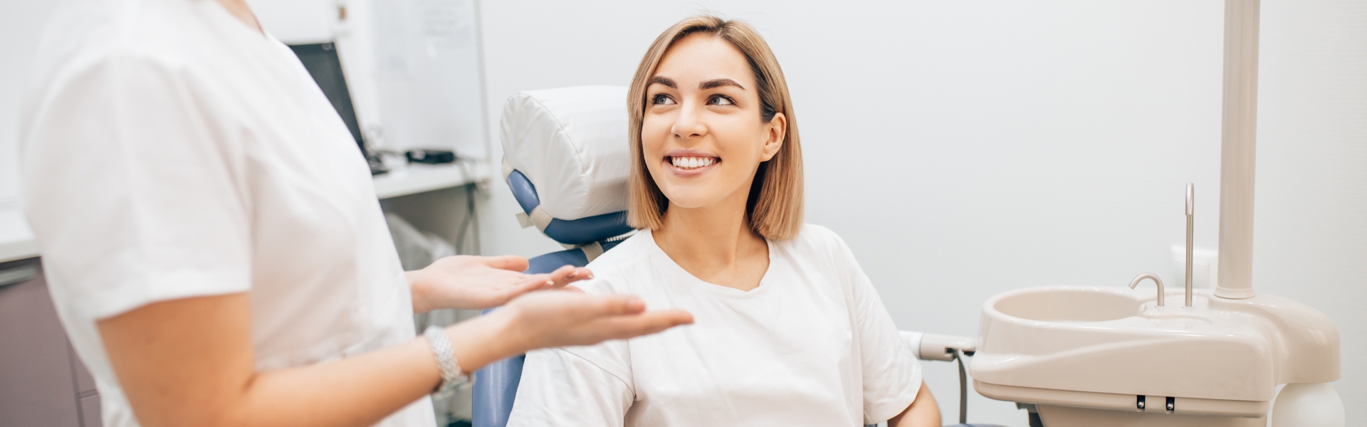 Woman dental patient smiling in chair at dental office