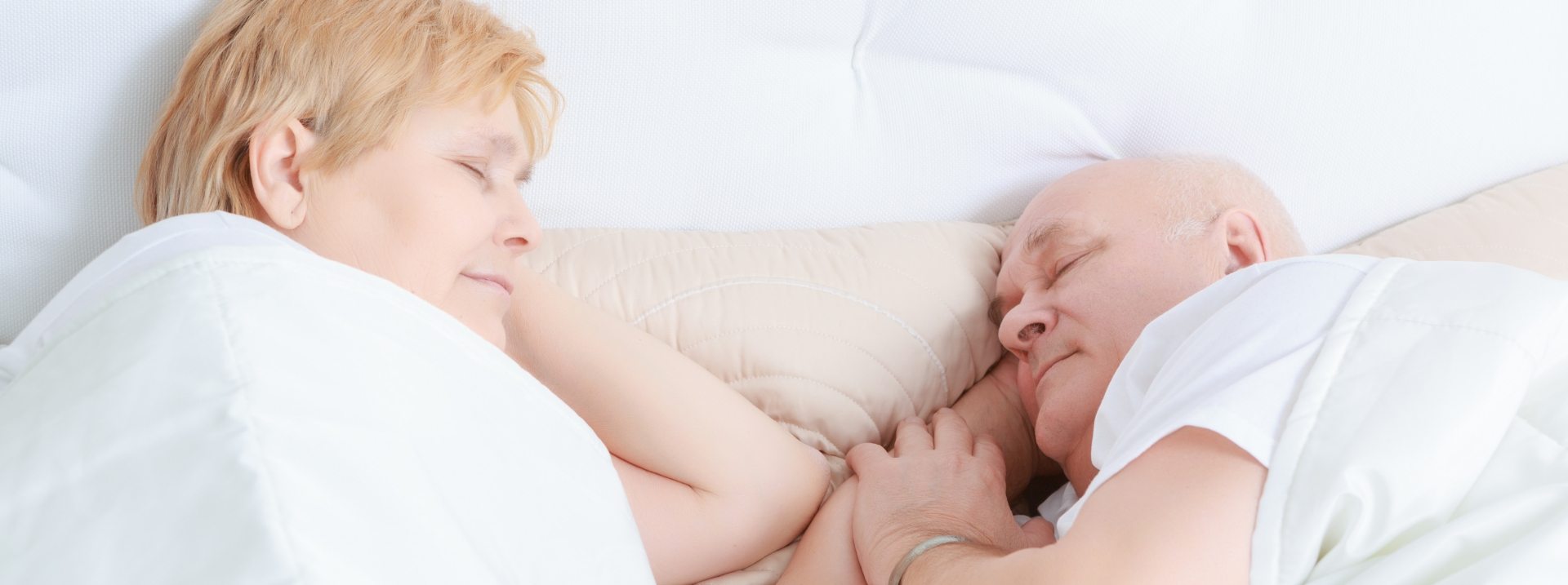 man and woman sleeping in bed