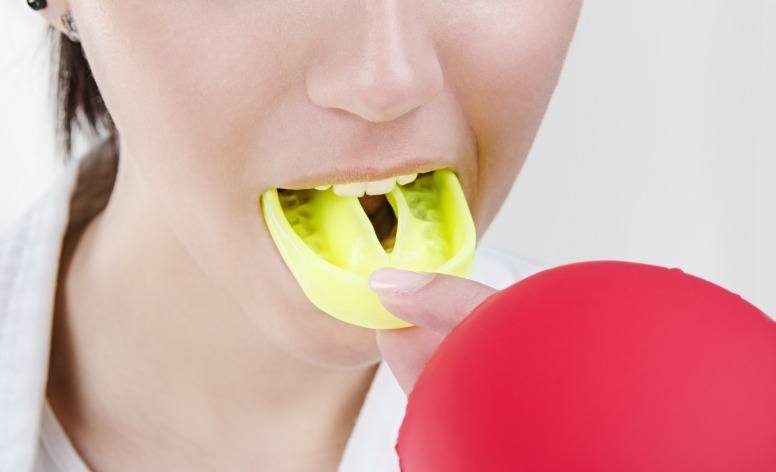 Teen placing an athletic mouthguard