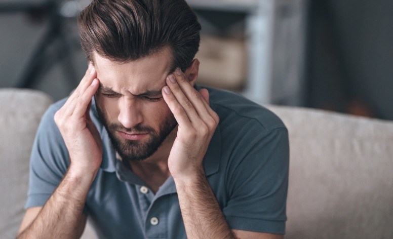 Man with migraine before nightguard usage