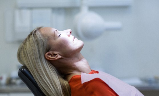 Blonde woman leaning back in dental chair and relaxing