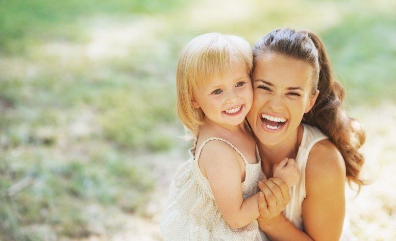 Woman and child smiling after Solea laser dentistry treatment
