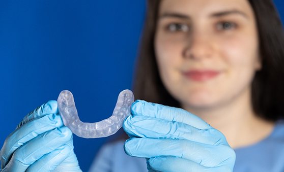 A dentist holding an occlusal splint