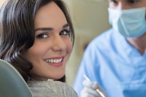 A woman smiling at her dental appointment.