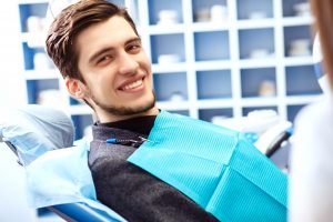 young man smiling in dentist chair