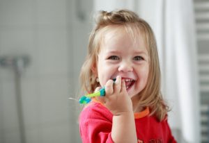 little girl with toothbrush