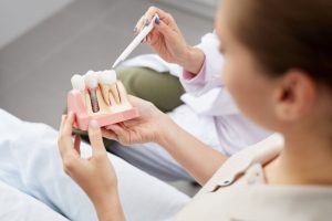 Patient discussing dental implants with dentist  