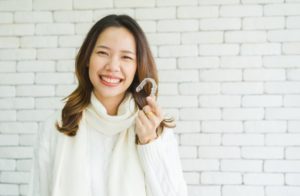 woman holding invisalign in fort worth