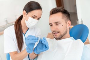 dentist showing patient invisalign tray