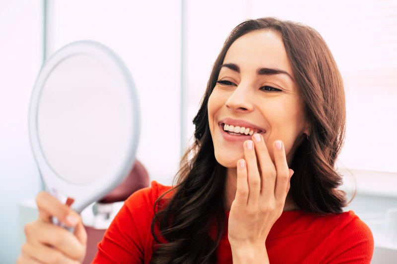 girl admiring dental implants