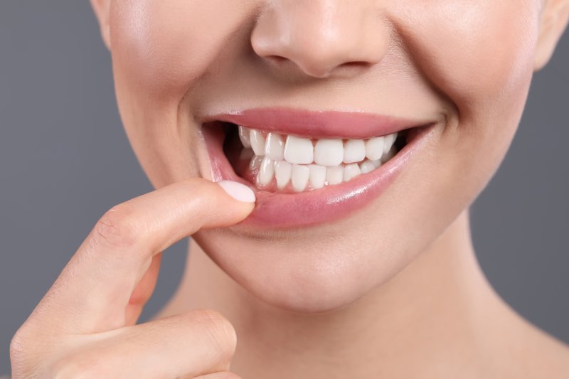 woman showing her gums while smiling