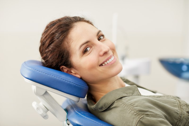 Smiling young woman in dentist chair