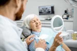 a patient smiling after transitioning to dental implants in Fort Worth