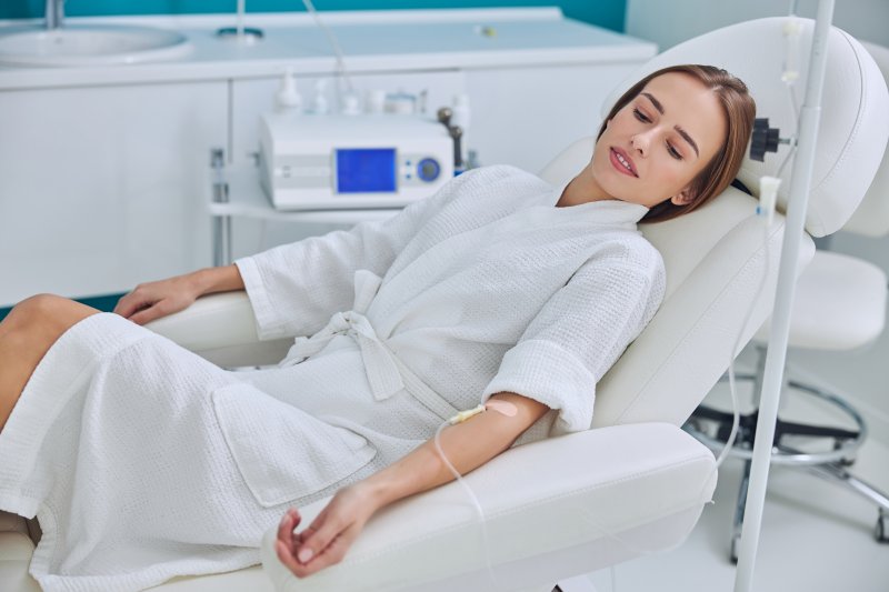 A woman in the dental chair under the effects of IV sedation
