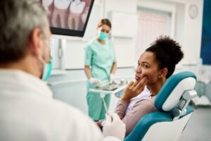 Woman at her dentist with upper toothache