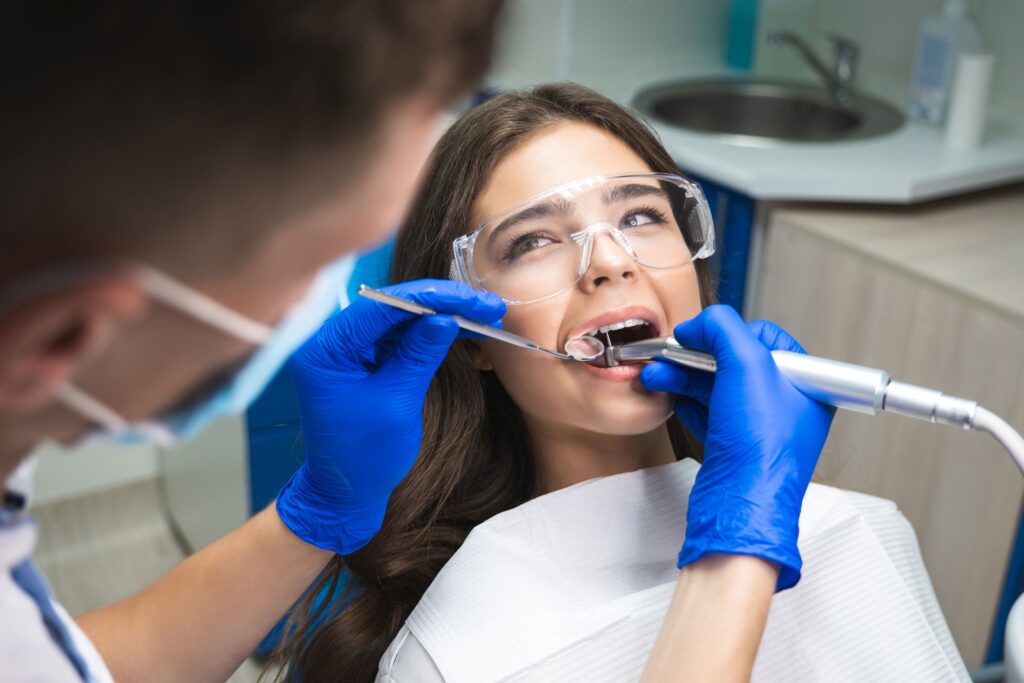Woman in clear goggles undergoing root canal