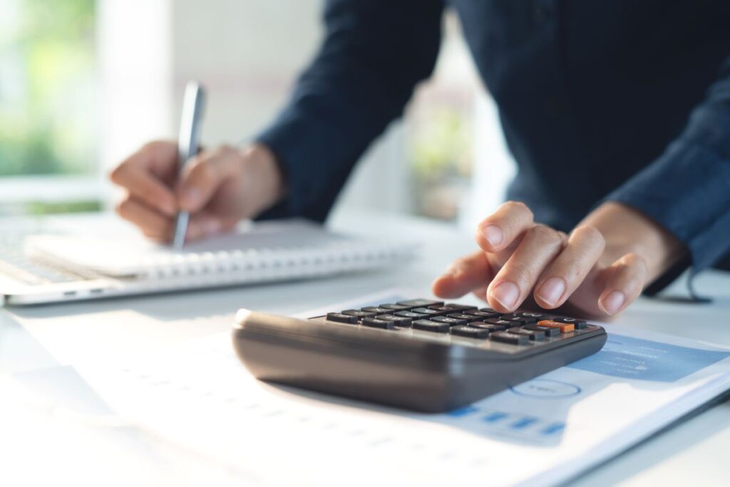 A person’s hand using a calculator